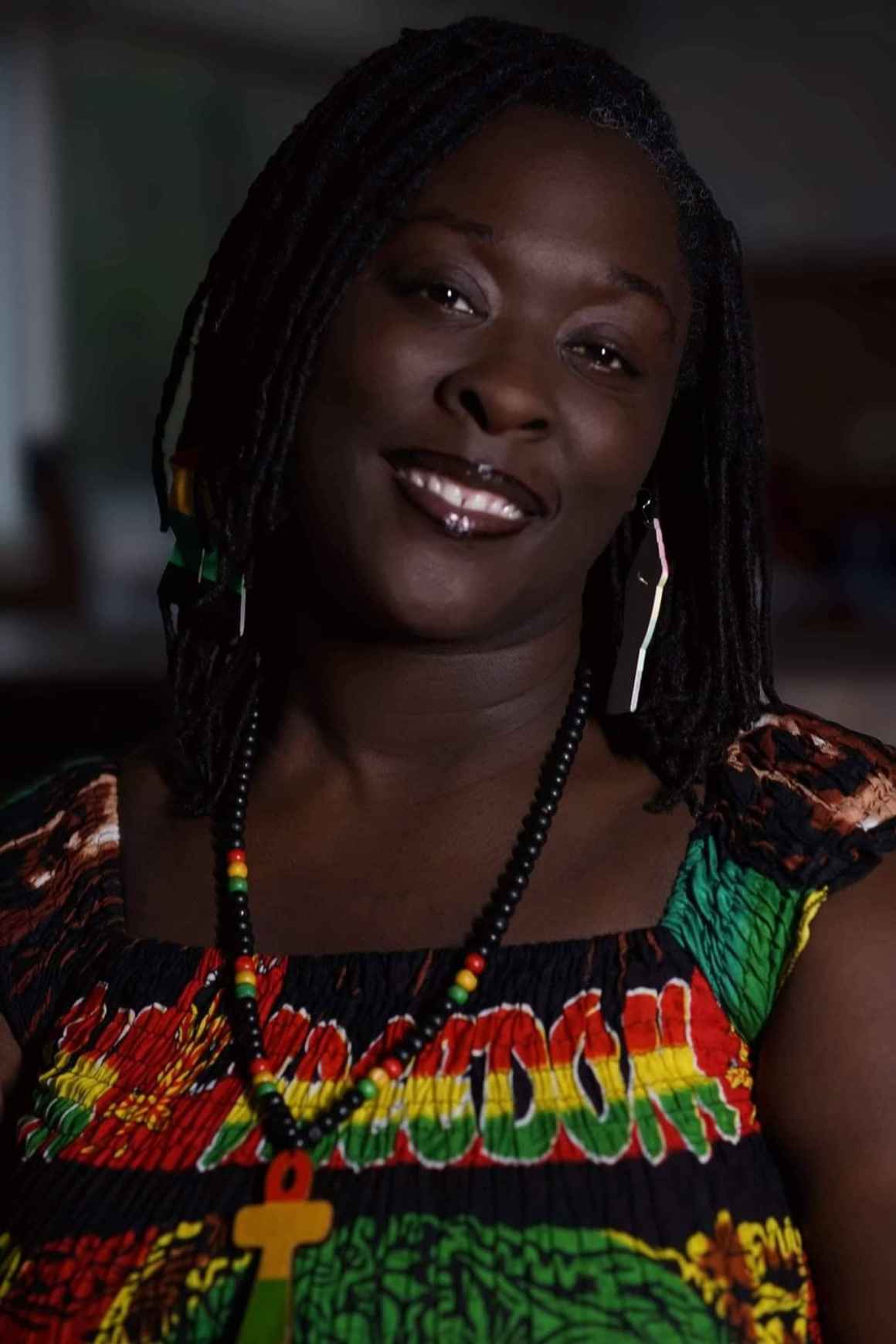 Portrait of Brittany Martin in a red, green, yellow, and black dress