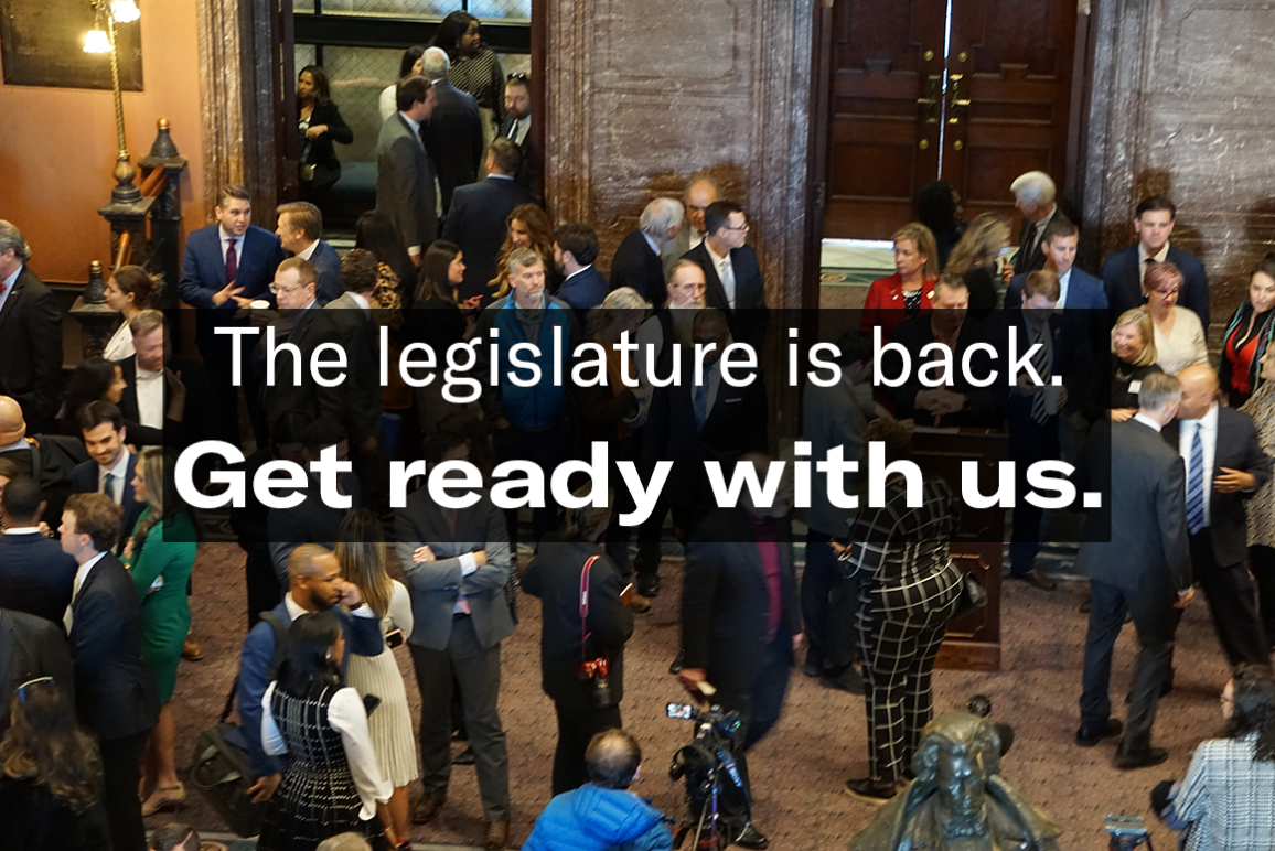 "The legislature is back. Get ready with us." Text is overlaid on an aerial-view photo of people milling around in the State House lobby.