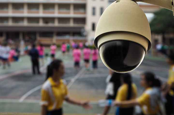 Surveillance camera mounted in front of a school yard