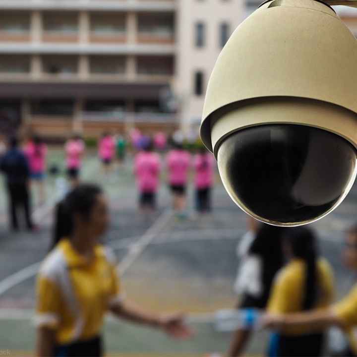 Surveillance camera mounted in front of a school yard