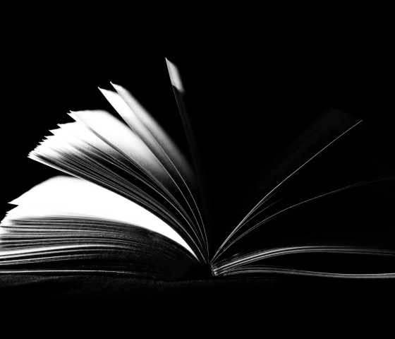 Black and white image of an open book.